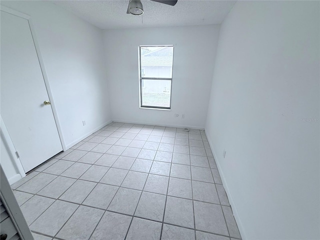 2423 Centennial Blvd, Leesburg, FL 34748 - spare room with light tile patterned flooring, baseboards, a ceiling fan, and a textured ceiling