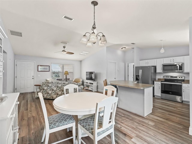 2111 Harston Trl, The Villages, FL 32162 - dining room with light wood-type flooring, lofted ceiling, and visible vents