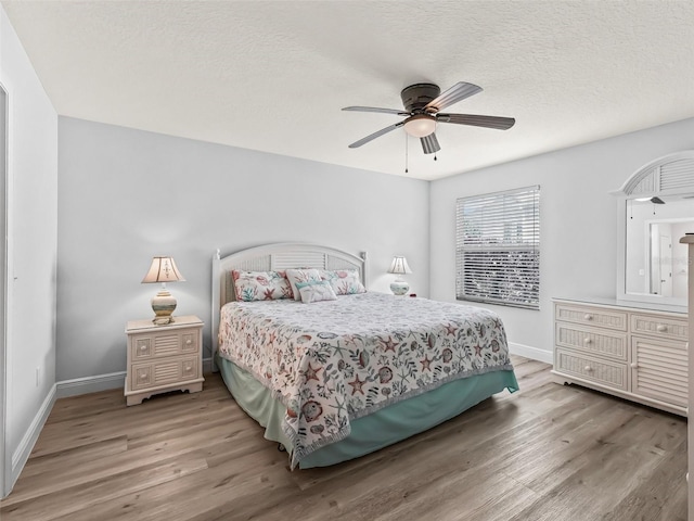 2111 Harston Trl, The Villages, FL 32162 - bedroom with baseboards, wood finished floors, and a textured ceiling