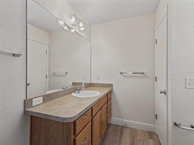 2111 Harston Trl, The Villages, FL 32162 - bathroom with baseboards, wood finished floors, and vanity