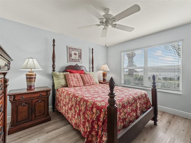 2111 Harston Trl, The Villages, FL 32162 - bedroom with a ceiling fan, light wood-style flooring, and baseboards