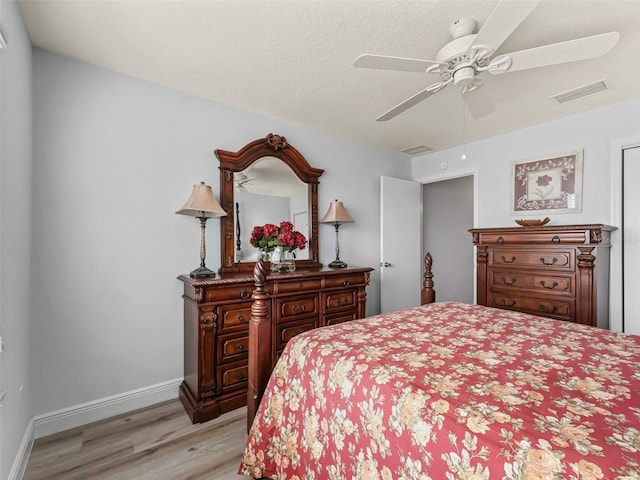 2111 Harston Trl, The Villages, FL 32162 - bedroom with baseboards, ceiling fan, visible vents, and light wood-type flooring