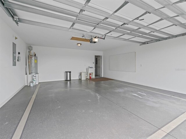2111 Harston Trl, The Villages, FL 32162 - garage with electric panel, a sink, a garage door opener, baseboards, and electric water heater