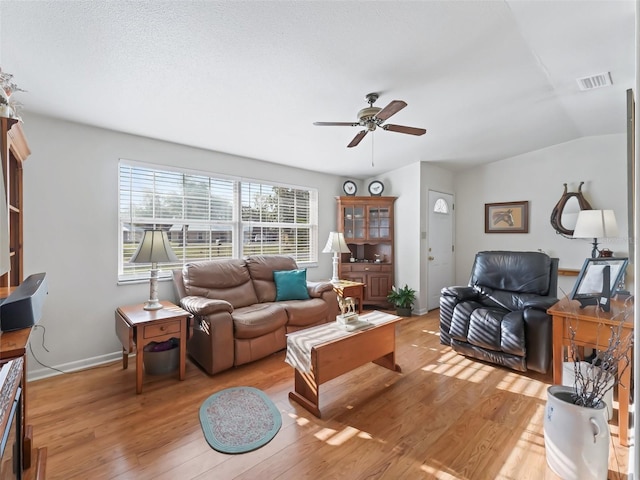 2376 Crk 444, Lake Panasoffkee, FL 33538 - living room featuring a ceiling fan, lofted ceiling, light wood finished floors, and visible vents