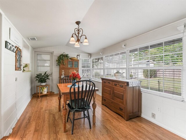 2376 Crk 444, Lake Panasoffkee, FL 33538 - dining space with light wood-style flooring, a notable chandelier, vaulted ceiling, and visible vents