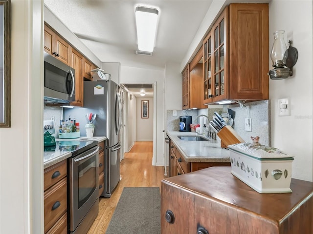 2376 Crk 444, Lake Panasoffkee, FL 33538 - kitchen with visible vents, brown cabinets, stainless steel appliances, a sink, and backsplash