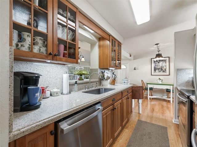 2376 Crk 444, Lake Panasoffkee, FL 33538 - kitchen featuring a sink, appliances with stainless steel finishes, and brown cabinetry