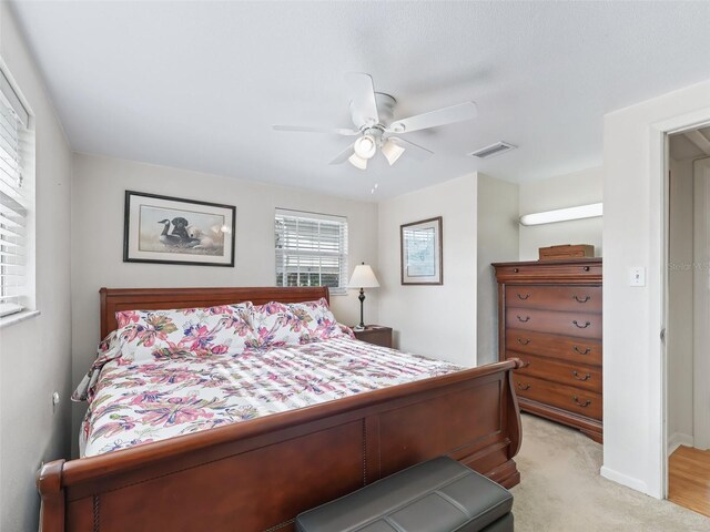 2376 Crk 444, Lake Panasoffkee, FL 33538 - bedroom featuring a ceiling fan, baseboards, light colored carpet, and visible vents
