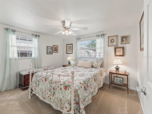 2376 Crk 444, Lake Panasoffkee, FL 33538 - bedroom featuring baseboards, a textured ceiling, ceiling fan, and light carpet