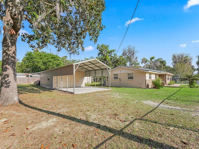 2376 Crk 444, Lake Panasoffkee, FL 33538 - rear view of house with fence, a lawn, a carport, driveway, and a patio area