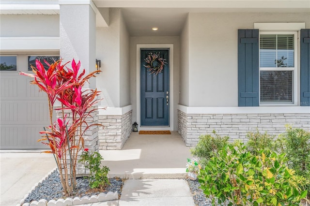 6003 Nightjar Ct, Okahumpka, FL 34762 - property entrance featuring brick siding, a garage, and stucco siding