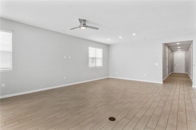 6003 Nightjar Ct, Okahumpka, FL 34762 - unfurnished room with light wood finished floors, baseboards, ceiling fan, and recessed lighting