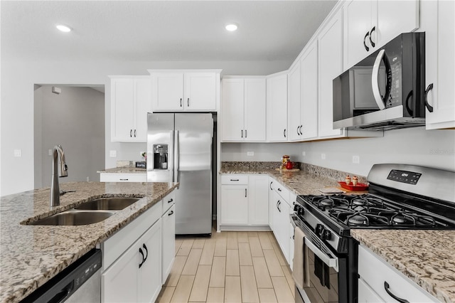 6003 Nightjar Ct, Okahumpka, FL 34762 - kitchen featuring wood finish floors, recessed lighting, appliances with stainless steel finishes, white cabinetry, and a sink