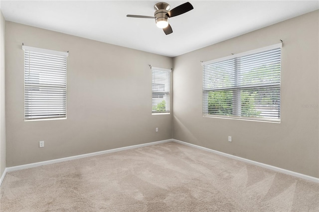 6003 Nightjar Ct, Okahumpka, FL 34762 - unfurnished room with baseboards, ceiling fan, and carpet flooring