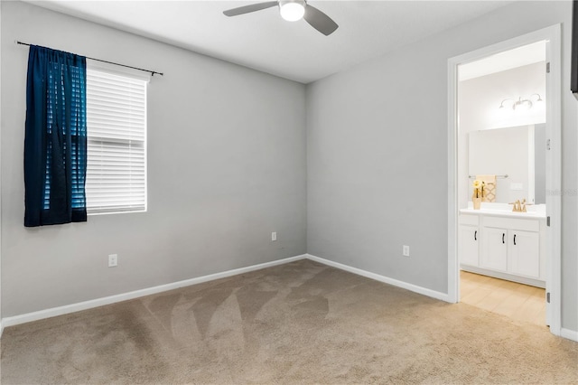 6003 Nightjar Ct, Okahumpka, FL 34762 - unfurnished bedroom with carpet, ensuite bathroom, ceiling fan, and baseboards