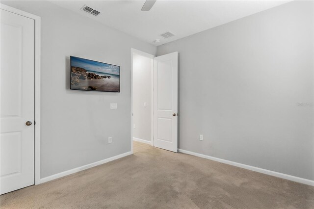 6003 Nightjar Ct, Okahumpka, FL 34762 - unfurnished bedroom with baseboards, visible vents, and carpet