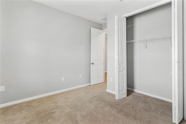 6003 Nightjar Ct, Okahumpka, FL 34762 - unfurnished bedroom featuring carpet flooring, baseboards, a closet, and visible vents