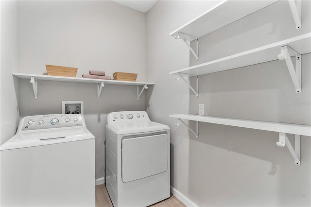6003 Nightjar Ct, Okahumpka, FL 34762 - washroom featuring independent washer and dryer, light wood-style floors, baseboards, and laundry area
