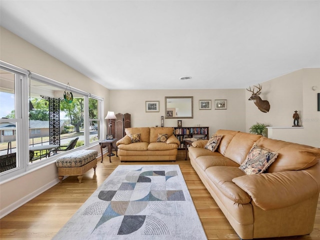 living room with baseboards and light wood-style floors