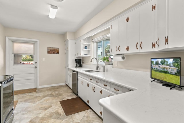 kitchen with a sink, white cabinetry, light countertops, and appliances with stainless steel finishes