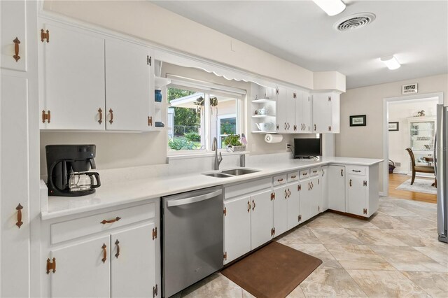 kitchen featuring light countertops, visible vents, appliances with stainless steel finishes, a sink, and open shelves