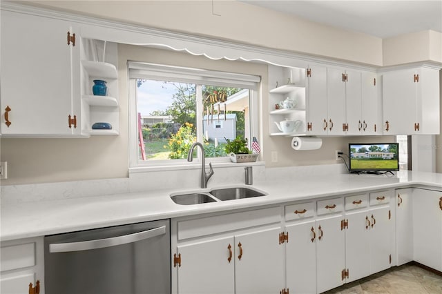 kitchen featuring light countertops, white cabinetry, a sink, open shelves, and stainless steel dishwasher