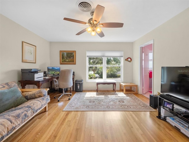 office space featuring visible vents, wood finished floors, and ceiling fan