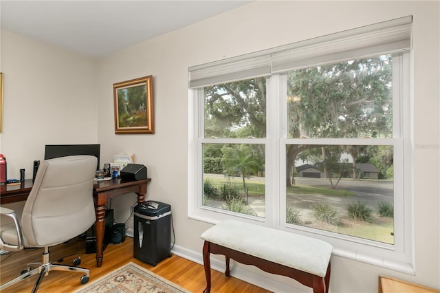 office area with baseboards and wood finished floors