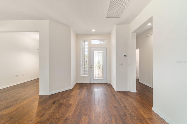 foyer with dark wood-style flooring, visible vents, baseboards, and recessed lighting