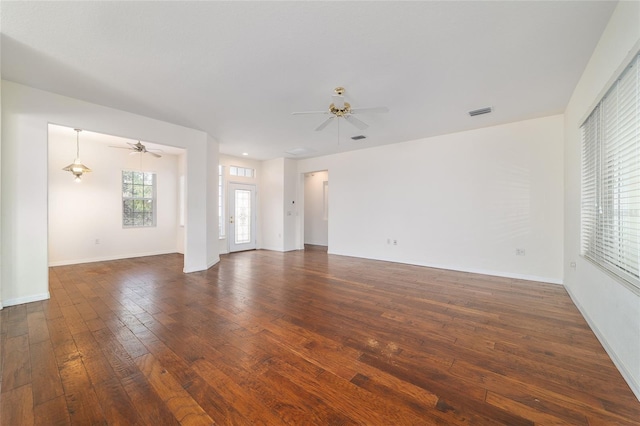 spare room featuring a ceiling fan, dark wood-type flooring, and visible vents