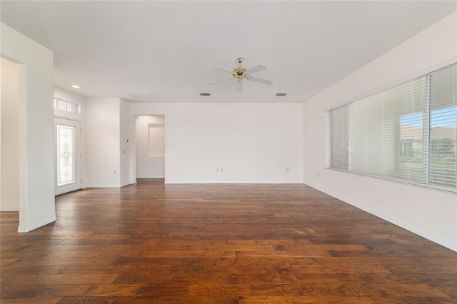 empty room featuring baseboards, visible vents, wood finished floors, and a ceiling fan