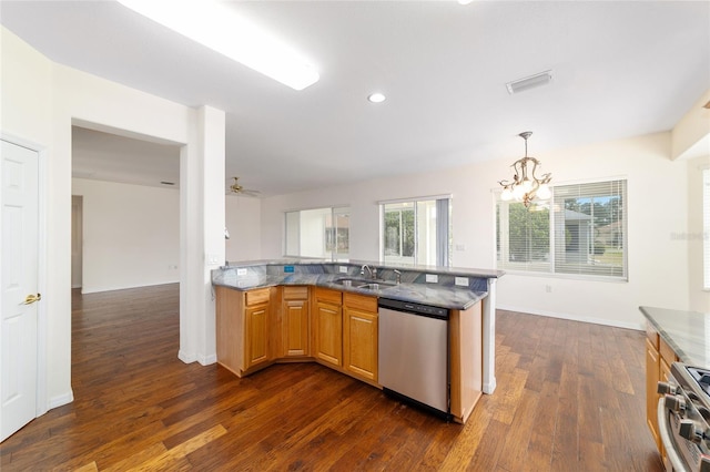 kitchen with dark wood-style flooring, stainless steel appliances, a sink, stone countertops, and visible vents