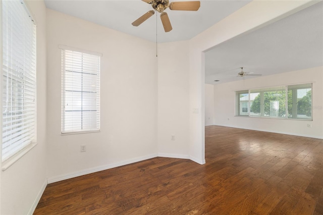 empty room with hardwood / wood-style flooring, baseboards, and ceiling fan