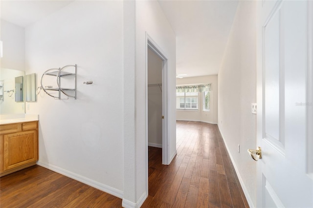 hallway with electric panel, dark wood-style floors, and baseboards