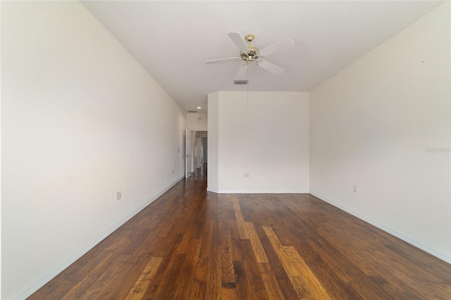empty room with baseboards, visible vents, wood finished floors, and a ceiling fan