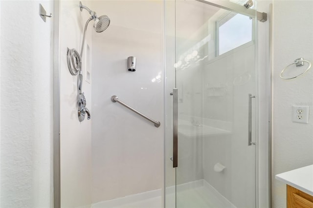 full bathroom with a stall shower and vanity