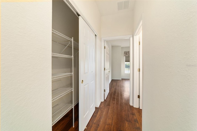 corridor with visible vents and wood finished floors