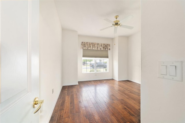 unfurnished room with baseboards, a ceiling fan, and wood-type flooring