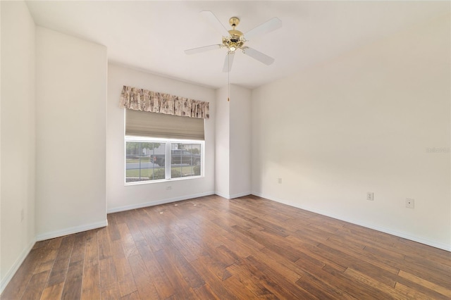unfurnished room featuring baseboards, a ceiling fan, and wood-type flooring