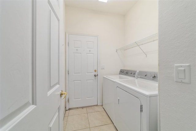 laundry room featuring light tile patterned flooring, washer and dryer, and laundry area