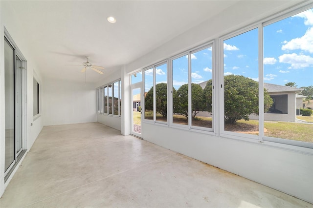 unfurnished sunroom with a ceiling fan