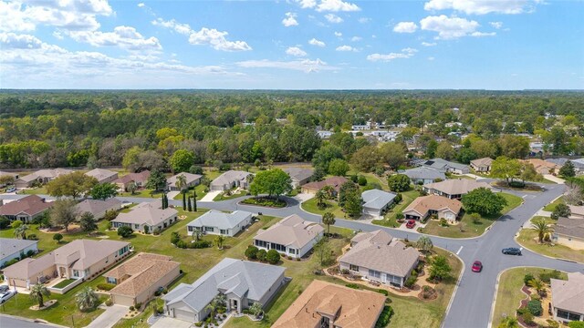 birds eye view of property with a view of trees and a residential view