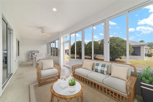 sunroom / solarium with concrete flooring, an outdoor living space, and ceiling fan