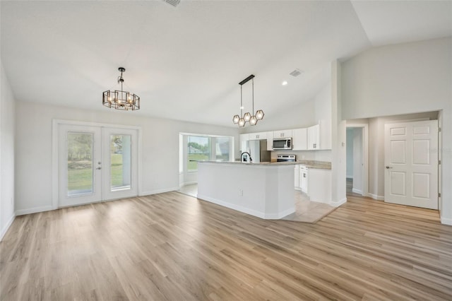 2575 SE 75th Blvd, Bushnell, FL 33513 - kitchen with a notable chandelier, light countertops, white cabinetry, appliances with stainless steel finishes, and light wood-style flooring