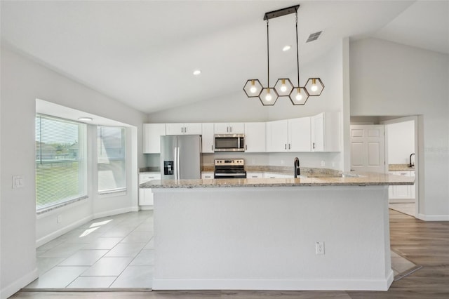 2575 SE 75th Blvd, Bushnell, FL 33513 - kitchen with light stone countertops, a peninsula, stainless steel appliances, visible vents, and white cabinets
