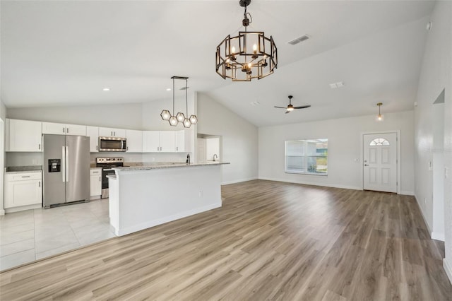 2575 SE 75th Blvd, Bushnell, FL 33513 - kitchen with pendant lighting, white cabinetry, open floor plan, stainless steel appliances, and ceiling fan with notable chandelier