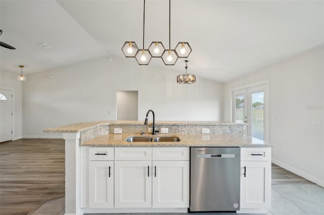 2575 SE 75th Blvd, Bushnell, FL 33513 - kitchen with vaulted ceiling, a sink, stainless steel dishwasher, hanging light fixtures, and white cabinets