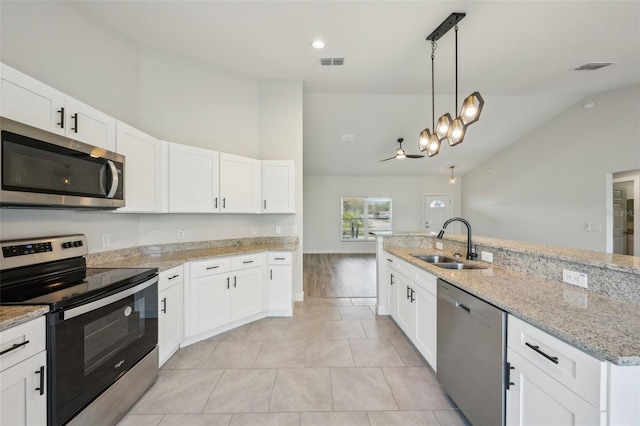 2575 SE 75th Blvd, Bushnell, FL 33513 - kitchen with a sink, white cabinetry, lofted ceiling, stainless steel appliances, and visible vents