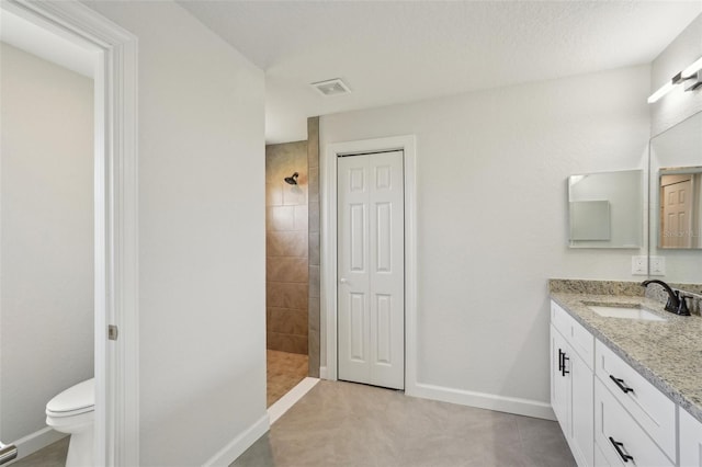 2575 SE 75th Blvd, Bushnell, FL 33513 - full bathroom featuring toilet, vanity, baseboards, and tiled shower