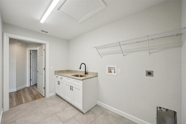 2575 SE 75th Blvd, Bushnell, FL 33513 - laundry room with hookup for an electric dryer, hookup for a washing machine, light tile patterned flooring, a sink, and visible vents
